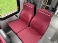 A pair of maroon upholstered seats inside a vehicle with the names "Steve & Cindy Mcpherson" and "Dr. Alan Murdock & Family" embroidered on the seat backs