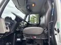 Interior view of a 2013 International DuraStar 4300 showing the driver's seat steering wheel and dashboard components