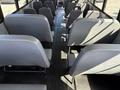Interior view of a 2011 Freightliner B2 showing rows of gray bus seats with aisles in between
