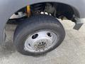 A close-up of a tire and wheel from a 2015 Ford F-550 showing the tread pattern and wheel studs