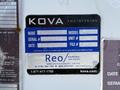 A blue and white machinery label displaying details such as make, model, serial number, unit number, and contact information for KOVA Engineering