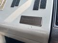A metallic nameplate embossed with the text Business Class by Freightliner attached to a vehicle's interior panel