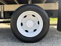 Close-up of a white wheel and tire from a 2018 Hino 195 featuring six lug nuts and a black tire with visible tread patterns