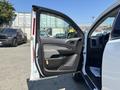 A 2017 Chevrolet Colorado with the driver's side door open showing the interior door panel and controls