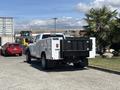 A 2021 RAM 5500 truck with a black dump bed is parked, showcasing its robust design and spacious rear compartment