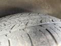 Close-up of a worn tire with visible tread patterns and wear marks on a 2018 Toyota Highlander