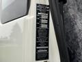 A label on a 2009 UD Trucks UD 3300 detailing specifications including manufacturer, axle information, safety standards, and vehicle identification number