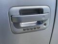 Close-up of the door handle of a 2014 Ford F-150 featuring a keypad for keyless entry with numbers ranging from 1 to 0