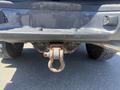 A rusted tow hitch attached to the rear of a 2010 Toyota Tacoma