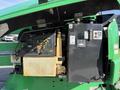 Close-up of a 2015 JLG 450AJ aerial lift control panel featuring various buttons gauges and a hydraulic fluid container