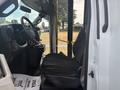 Side view of a 2020 Chevrolet Express showing the driver's seat and dashboard with steering wheel and controls