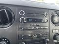 Dashboard of a 2014 Ford F-250 SD featuring a CD player radio climate control knobs and display screen