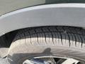Close-up of a black 2022 Kia Sorento tire showing detailed tread patterns and a portion of the wheel rim