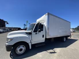 A white 2014 International TerraStar truck with a large cargo box and a single cab parked on a lot