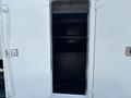 A 2006 Sterling Acterra truck with an open door revealing a dark interior space