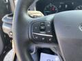 Close-up of the steering wheel of a 2025 Ford Transit T-350 featuring control buttons for cruise control and audio functions