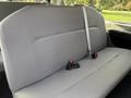 The interior of a 2013 Ford E-350 Super Duty showing a gray bench seat with seatbelts