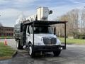 A 2012 International DuraStar 4300 truck with an extended boom lift and a large storage compartment in the back
