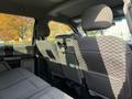 The image shows the interior of a 2019 Ford F-550 with gray cloth seats and headrests visible from the backseat perspective