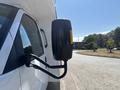 A side mirror of a 2020 Chevrolet Express van positioned towards the viewer