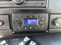 A control panel featuring buttons and a display screen with settings for climate control in a 2020 Chevrolet Express