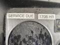 Close-up of a dashboard display showing "SERVICE DUE" and "1706 HR" labels with a dirty surface on a Kubota RTV 900 vehicle