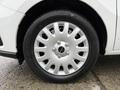 Close-up of a silver wheel with a circular design and five spokes mounted on a black tire featuring the brand name in white letters