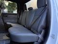 A 2021 RAM 5500 rear interior seat with gray fabric upholstery and seatbelts visible