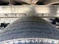 Close-up of a large tire from a 2022 Isuzu NRR truck showing detailed tread pattern and sidewall design