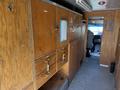 Interior view of a 2009 Morgan Olson Workhorse W62 featuring wooden cabinetry with drawers and hooks along the sides