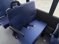 A blue nylon seat with a seatbelt in a 2020 Chevrolet Express van interior