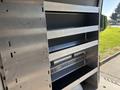 A metal shelving unit inside a 2024 Mercedes-Benz Sprinter 2500 with multiple levels for storage and organization