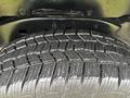 Close-up of a tire from a 2011 Chevrolet Colorado showing the tread pattern and grooves