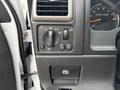 Interior controls of a 2011 Chevrolet Colorado including headlight settings and an electronic parking brake button