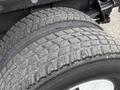 Close-up of a tire on a 2006 International 4200 showcasing detailed tread pattern and wear with visible brand markings on the sidewall