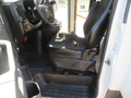 Interior of a 2020 Chevrolet Express showing the driver's seat and steering wheel with the ignition key in the seat area