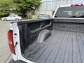 A 2018 Chevrolet Silverado 1500 truck bed with a dark, textured surface and a visible wheel well on the left side