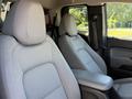 Gray front seats of a 2018 GMC Canyon with a center console in between