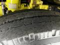 A close-up view of a cracked tire on a 1995 Freightliner FL086 showcasing the tread pattern and wear on the rubber surface