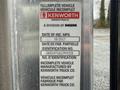 A metal identification plate for a Kenworth T800 truck with details including the date of manufacture and vehicle identification number