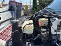 Engine compartment of a 2007 GMC C4500 TopKick with visible coolant reservoirs and various engine components