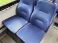 Two blue fabric seats designed for a Chevrolet Express van with a textured surface and a compact design