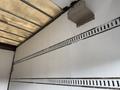 A 2014 Hino 195 truck with a simple interior design featuring white walls and horizontal ventilation slats
