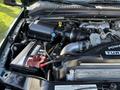 Engine compartment of a 2008 Ford F-550 featuring a turbocharger battery and various engine components with visible wires and hoses