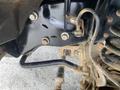 Close-up view of a 2015 Ford F-550's chassis showing suspension components and mounting points with visible bolts and dirt accumulation