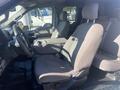 Interior of a 2017 Ford F-150 showing front seats and center console with fabric upholstery and a steering wheel