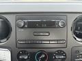 Dashboard control panel of a 2009 Ford F-450 Super Duty featuring a display and various audio and climate control buttons