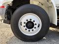 Close-up of a large wheel from a 2012 International DuraStar 4300 showcasing the tire tread and metallic rim with lug nuts