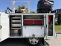 2020 Ram 2500 with an open storage compartment showcasing red toolboxes and various equipment inside