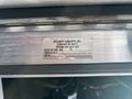 A metal plate displaying information about a 2020 Freightliner MT45 including company name contact details manufacturing date and vehicle ID